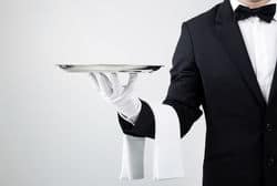 stock photo waiter holding empty silver tray over gray background 129940547